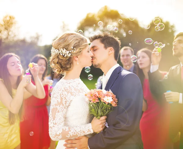 Newlyweds kissing at wedding reception