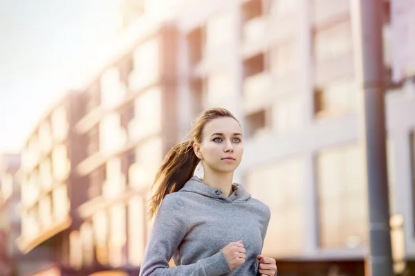 Female runner is jogging in the street
