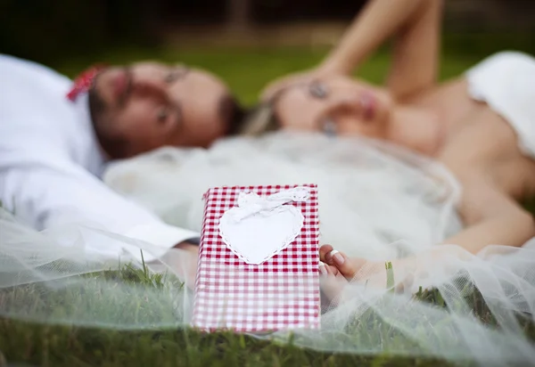 Bride and groom lying on grass