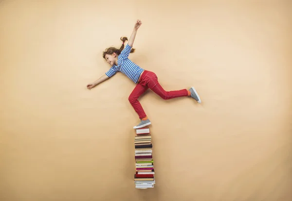 Girl is playing with group of books