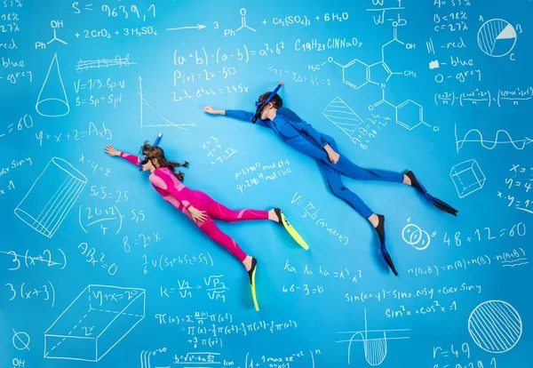 Children scuba diving in between math formula