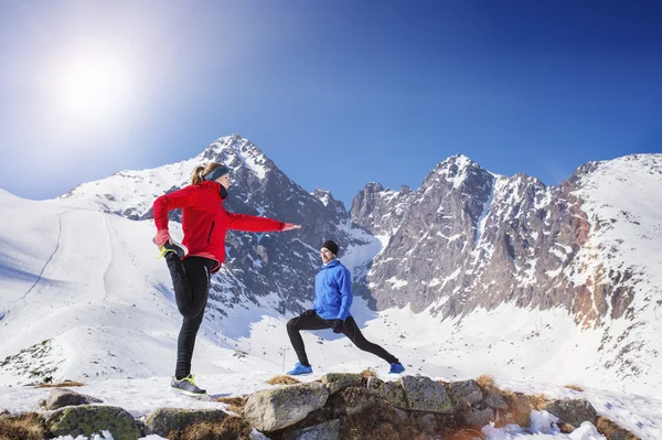 Couple stretching in winter