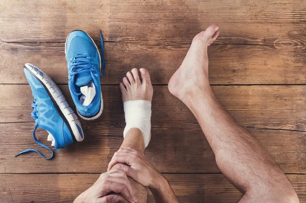 Injured runner with blue shoes