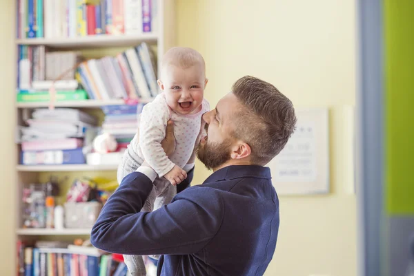 Father holding his daughter