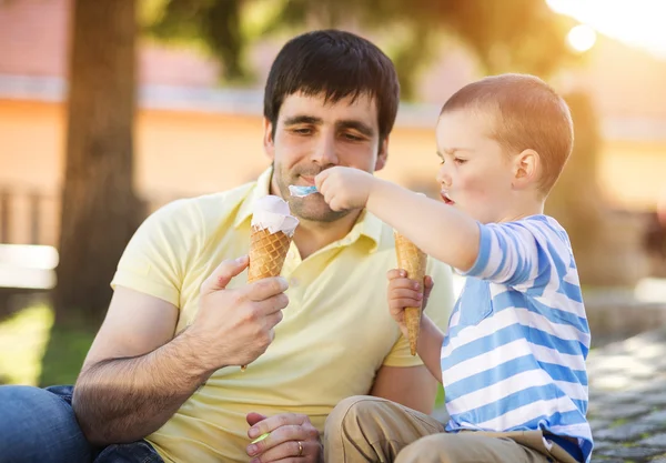 Father and son enjoying ice cream
