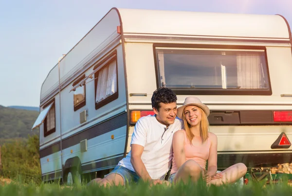 Couple travelling with camper
