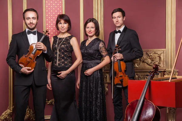 Classical music quartet posing after the concert.