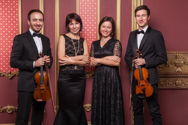 Classical music quartet posing after the concert.