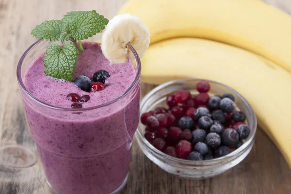 Smoothie of banana, berries frozen cranberries and blueberries w