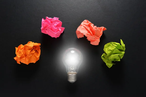 Great idea solution concept with crumpled colorful paper and light bulb