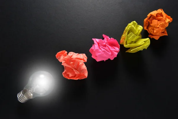 Great idea solution concept with crumpled colorful paper and light bulb