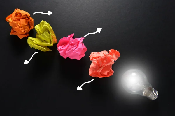 Great idea solution concept with crumpled colorful paper and light bulb