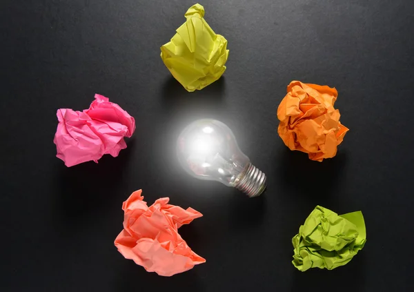Great idea solution concept with crumpled colorful paper and light bulb