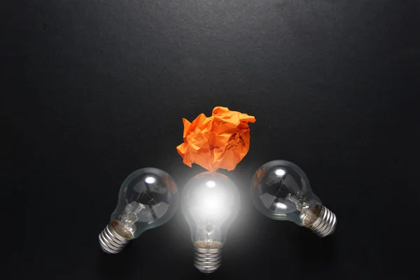 Great idea solution concept with crumpled colorful paper and light bulb