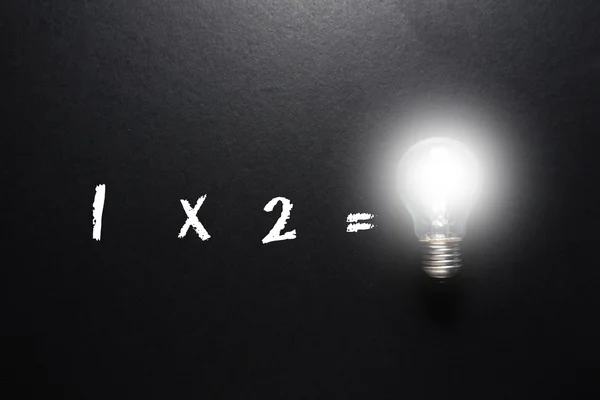 Great idea math concept with light bulb on black background