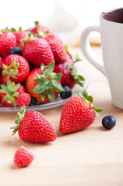 Strawberry breakfast with juice and coffee on wooden table