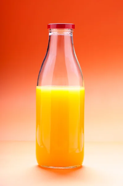 Orange juice bottle isolated on color background