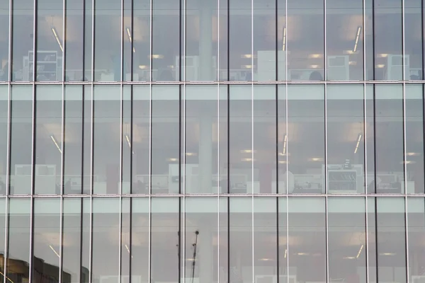 Close up of modern glass building with reflections