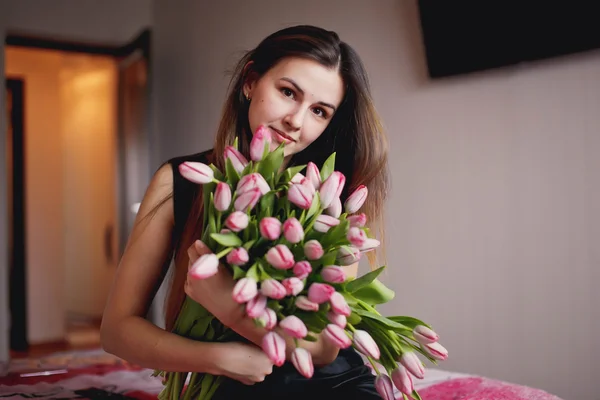 Smiling woman with a bouquet of flowers