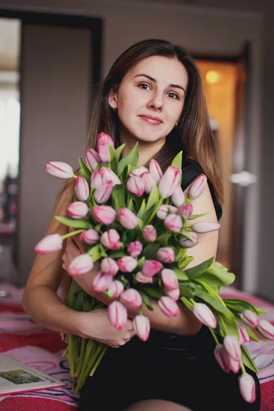 Smiling woman with a bouquet of flowers