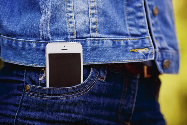 Smartphone in everyday life. phone in jeans pocket.