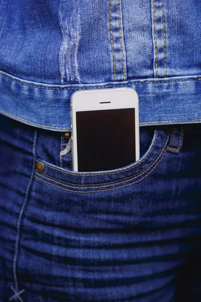 Smartphone in everyday life. phone in jeans pocket.