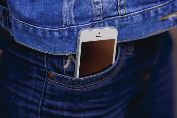 Smartphone in everyday life. phone in jeans pocket.