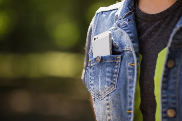 Smartphone in everyday life. phone in jeans pocket.