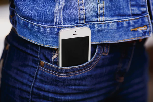 Smartphone in everyday life. phone in jeans pocket.