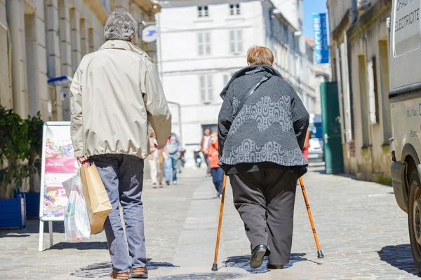 Two old persons walking