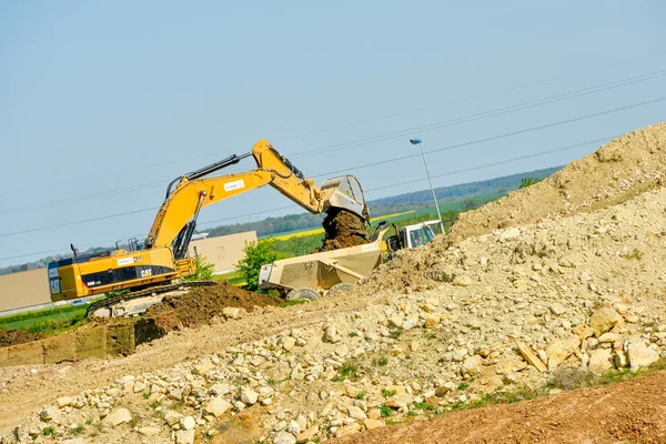Industrial excavator loading soil