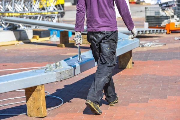 A worker in purple blouse walking around construction area