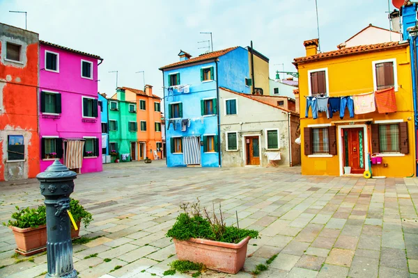 BURANO, ITALY - MAR 20 - Colorful houses in Burano with the laundry drying on a wire near Venice on Mars 20, 2015, Italy.