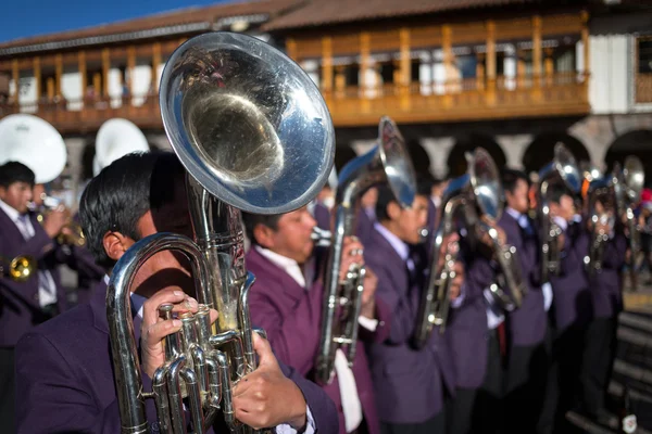 Unknown musicians of a brass band on parade in Cuzco, Peru