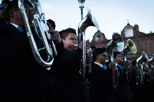 Unknown musicians of a brass band on parade in Cuzco, Peru