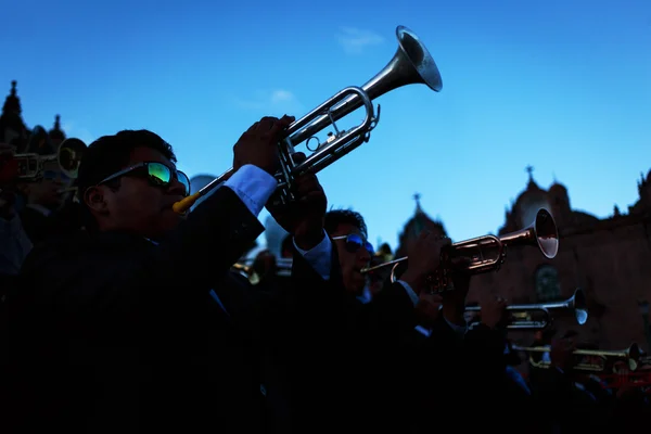 Unknown musicians of a brass band on parade in Cuzco, Peru