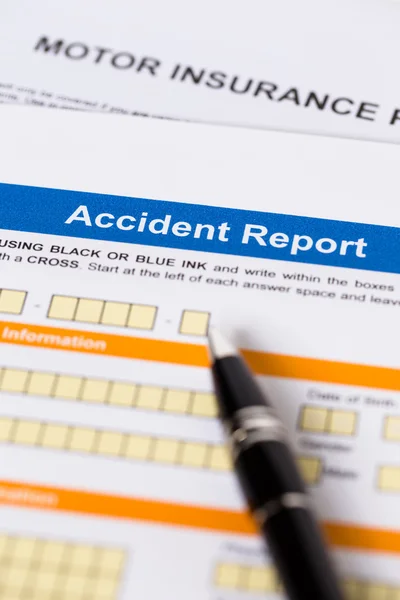 Motor or car insurance accident report form with pen