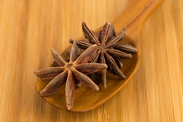 Anise stars in wooden spoon