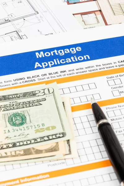 Mortgage application with pen, banknote, and drawing