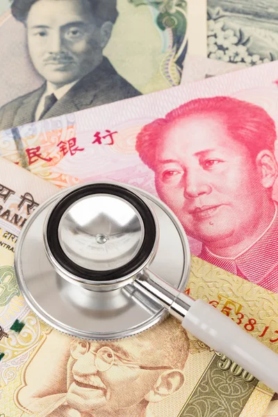 Stethoscope on asian banknote concept financial health check