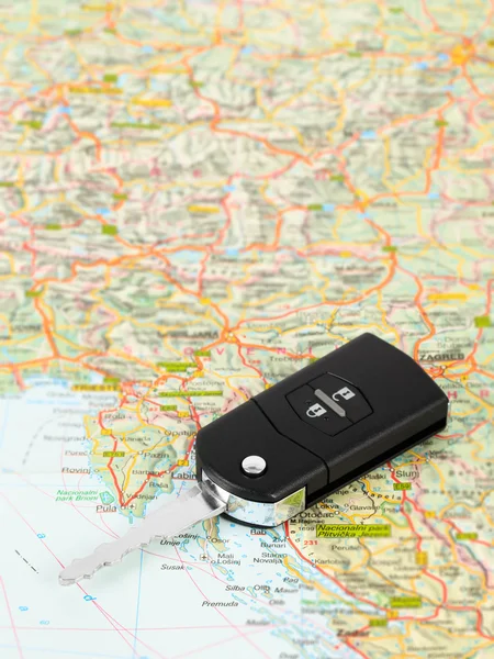Car key on street map travel concept