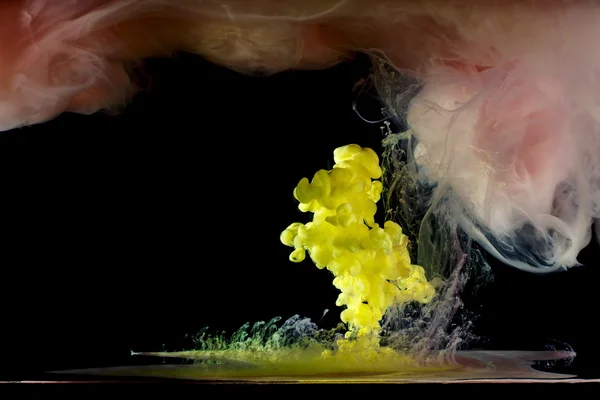 Liquid multi-colored paint mixed moving in water