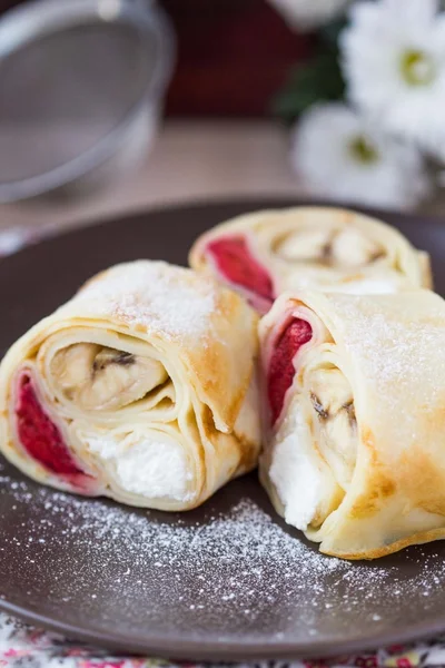 Delicious pancake rolls with three toppings, cheese, strawberrie