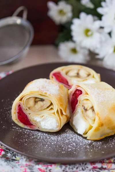 Delicious pancake rolls with three toppings, cheese, strawberrie