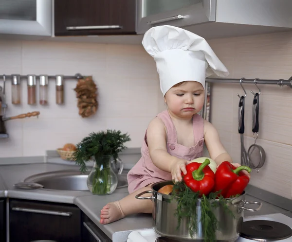 Child looks at vegetables