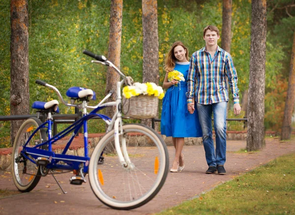 Beautiful young couple goes to a tandem bike ride