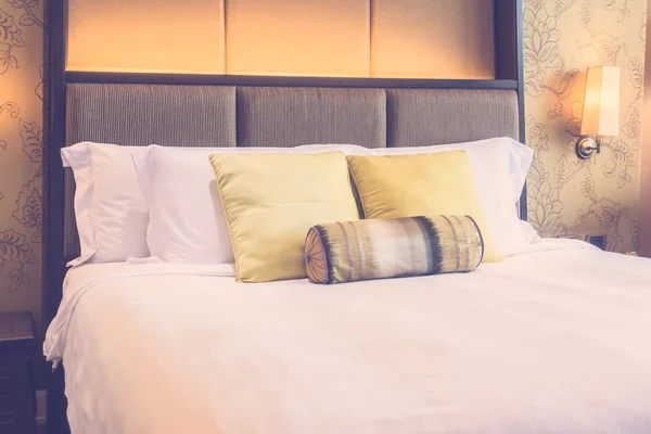 Luxury pillows on bed with light lamp