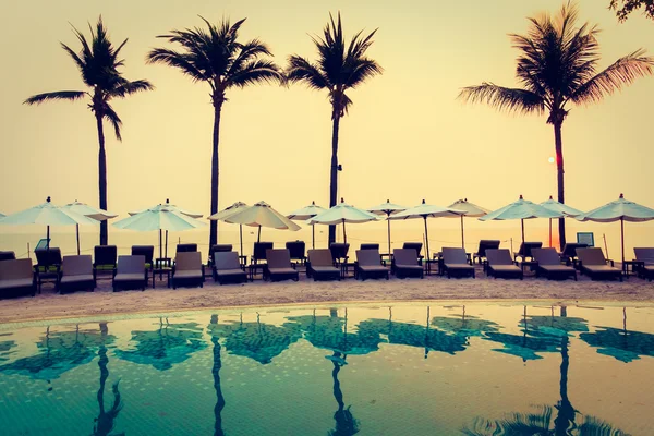 Swimming pool in hotel resort at sunrise