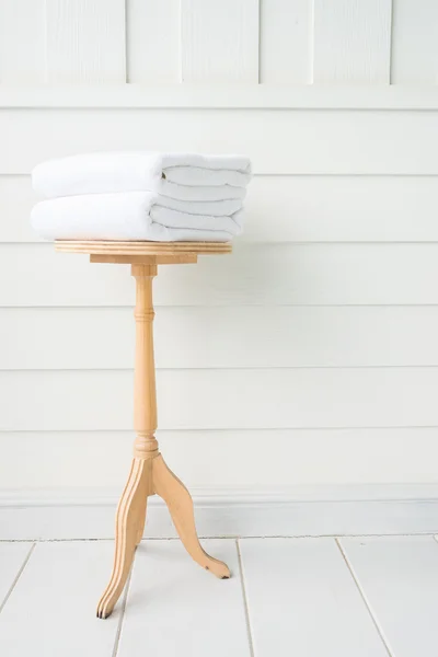 Towels in bath on wood table