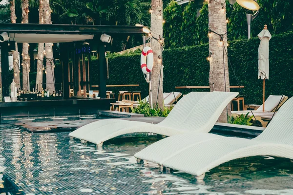 Luxury pool Chairs in hotel swimming pool